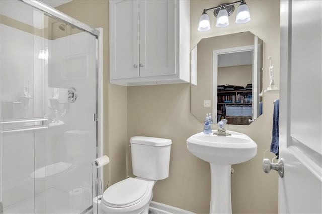 bathroom with toilet and walk in shower