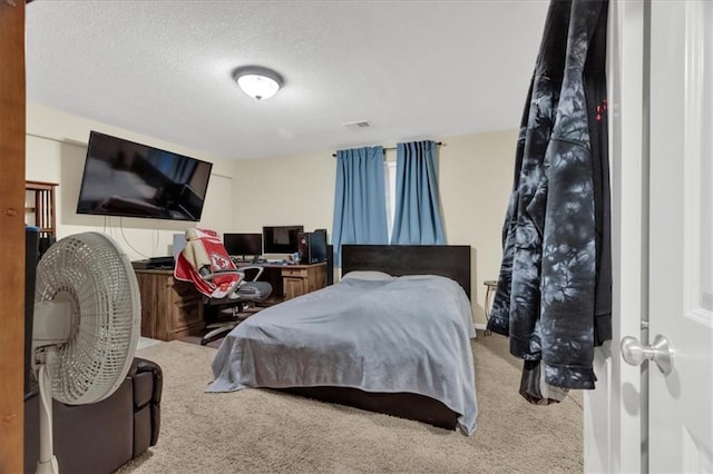 carpeted bedroom featuring a textured ceiling