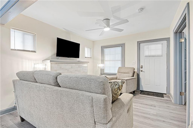 living room with ceiling fan and light hardwood / wood-style floors