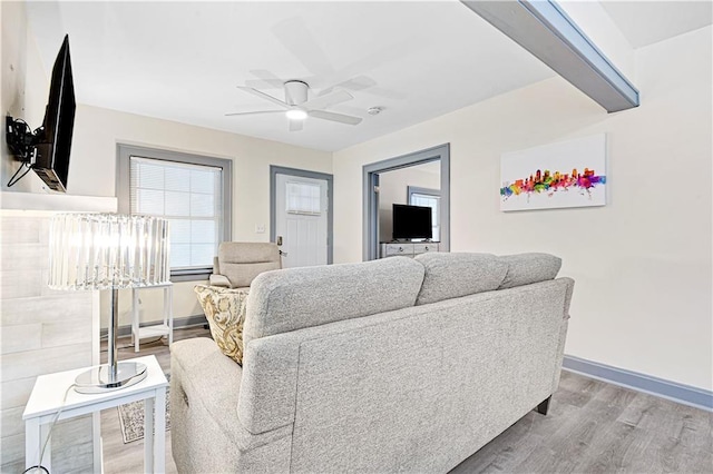 living room featuring hardwood / wood-style floors and ceiling fan