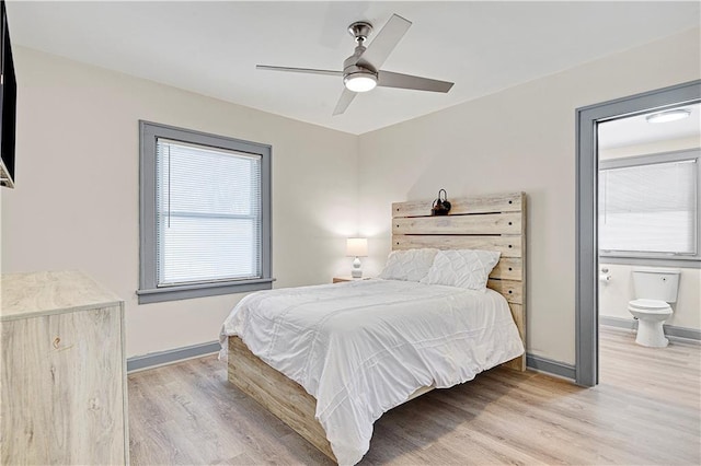 bedroom featuring connected bathroom, light hardwood / wood-style flooring, and ceiling fan