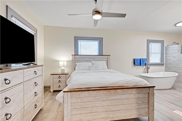 bedroom with ceiling fan and light hardwood / wood-style floors