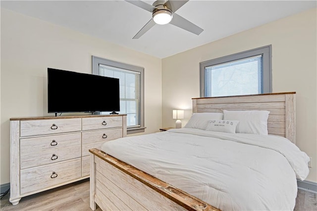 bedroom with light hardwood / wood-style floors and ceiling fan