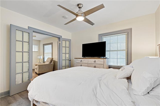 bedroom with ceiling fan, french doors, and hardwood / wood-style floors