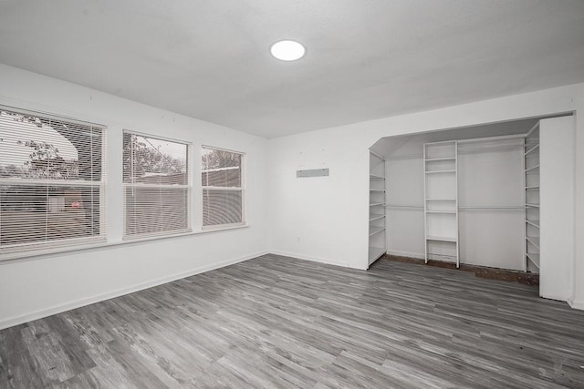 unfurnished bedroom featuring dark hardwood / wood-style floors and a closet