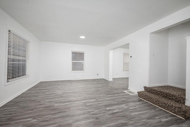 unfurnished room with dark wood-type flooring