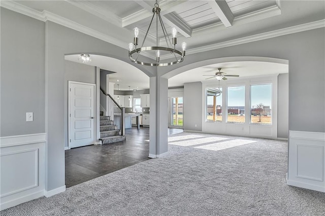 interior space featuring coffered ceiling, beam ceiling, ornamental molding, and dark colored carpet