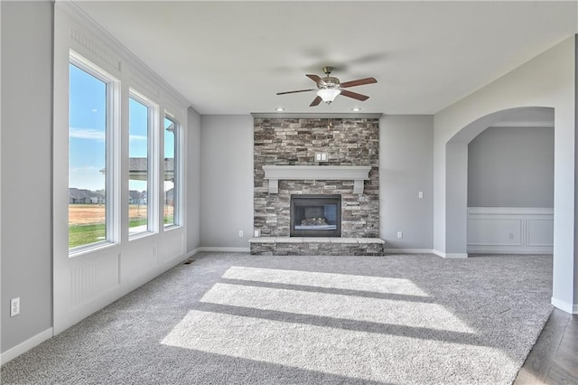 carpeted living room featuring ceiling fan and a fireplace