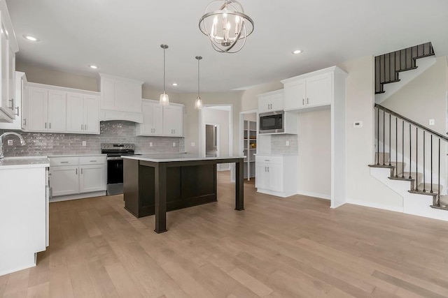 17165 W 164th Ter, Olathe, KS 66062 - kitchen with stainless steel appliances, tasteful backsplash, white cabinetry, a breakfast bar, and recessed lighting