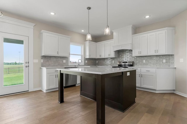 17165 W 164th Ter, Olathe, KS 66062 - kitchen featuring appliances with stainless steel finishes, light countertops, a kitchen island, white cabinetry, and recessed lighting