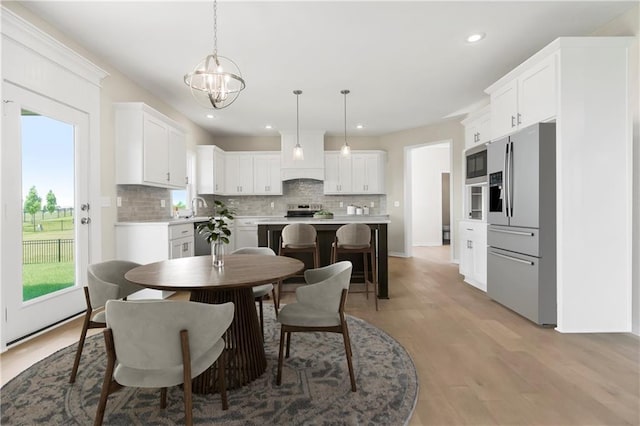 17165 W 164th Ter, Olathe, KS 66062 - dining space featuring a chandelier, healthy amount of natural light, recessed lighting, and light wood finished floors