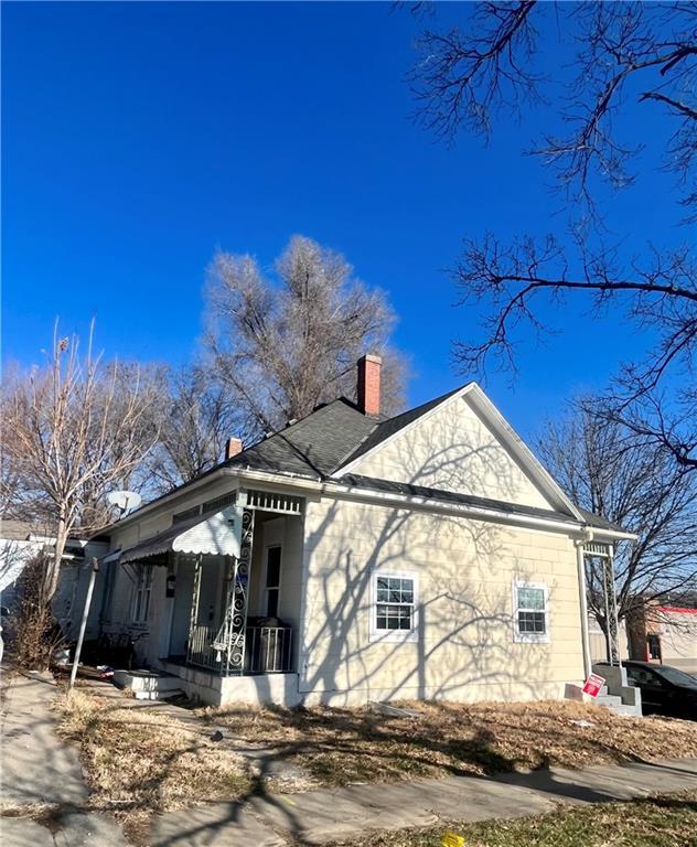 view of side of home with covered porch