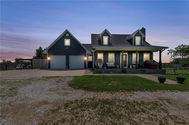 view of front facade featuring a porch, a garage, and a yard