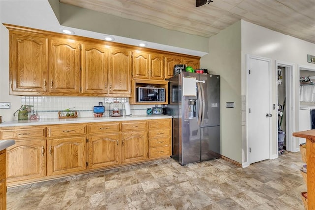 kitchen with backsplash, stainless steel refrigerator with ice dispenser, and black microwave