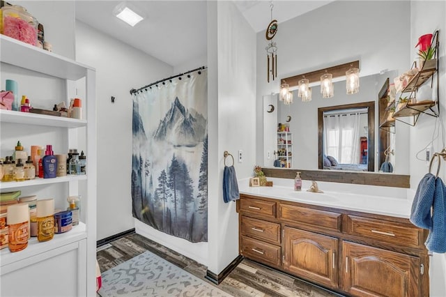 bathroom with vanity, wood-type flooring, and walk in shower