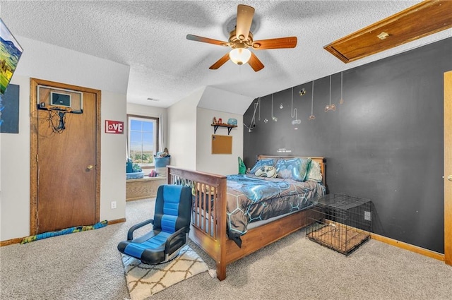 bedroom with ceiling fan, carpet floors, ensuite bathroom, and a textured ceiling