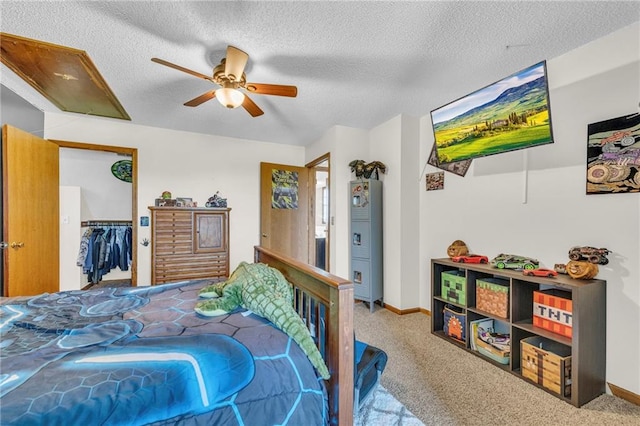 carpeted bedroom with a textured ceiling, a closet, and ceiling fan