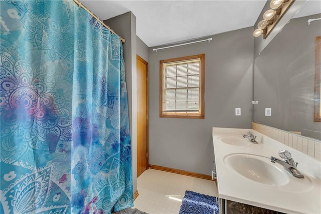 bathroom with curtained shower and vanity