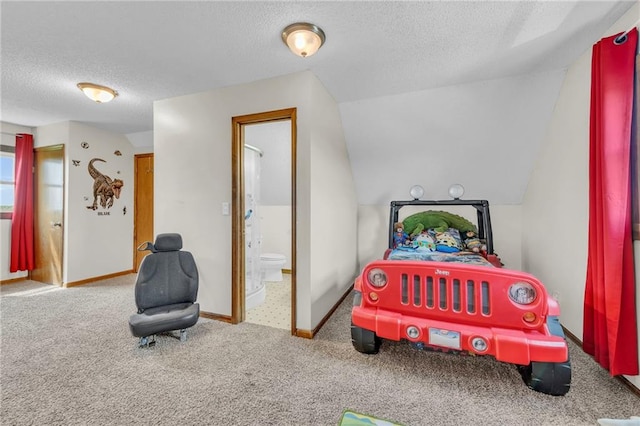 bedroom featuring carpet, a textured ceiling, ensuite bathroom, and vaulted ceiling