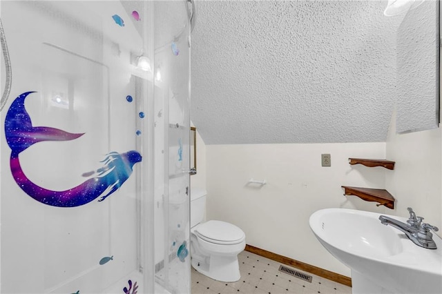 bathroom with toilet, sink, lofted ceiling, and walk in shower