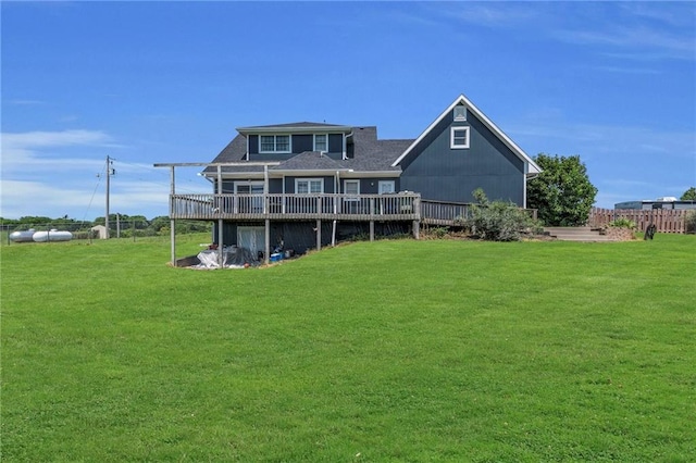 back of property with a lawn and a wooden deck