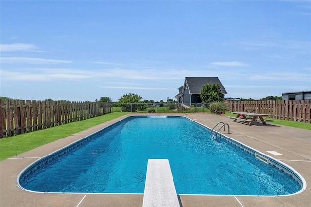 view of pool featuring a diving board and a patio area