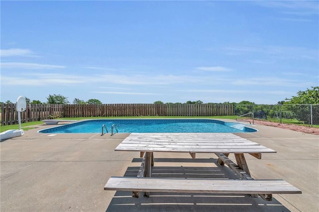 view of pool featuring a diving board and a patio