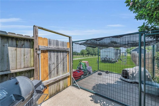 view of gate featuring a lawn