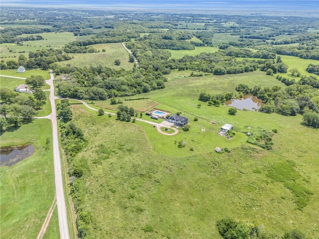 birds eye view of property with a rural view and a water view