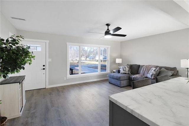 living room featuring dark hardwood / wood-style floors and ceiling fan