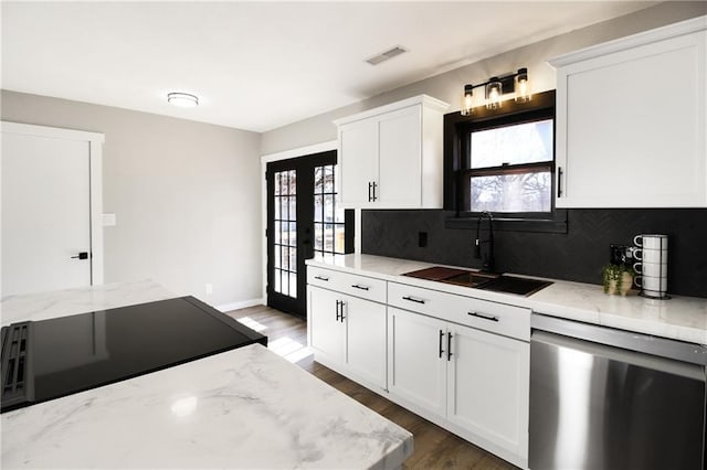 kitchen with white cabinetry, stainless steel dishwasher, plenty of natural light, and sink