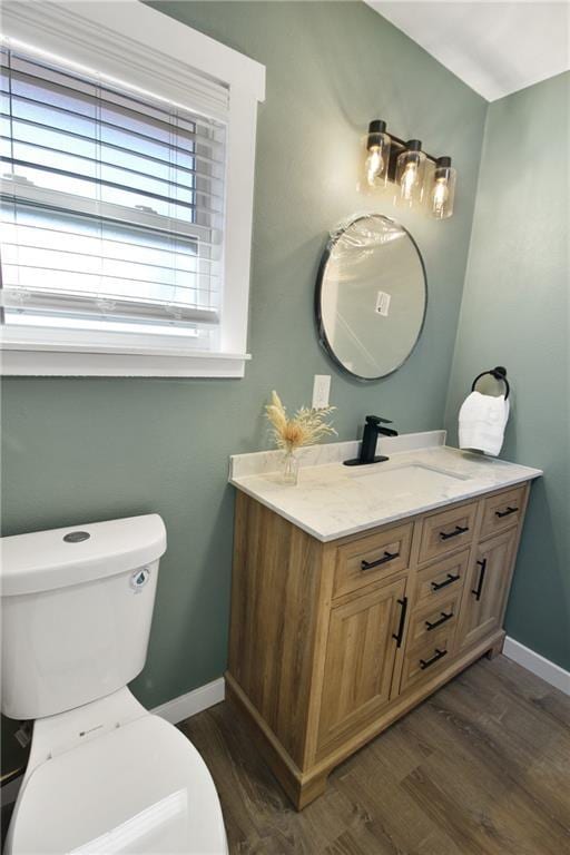 bathroom featuring hardwood / wood-style flooring, vanity, and toilet