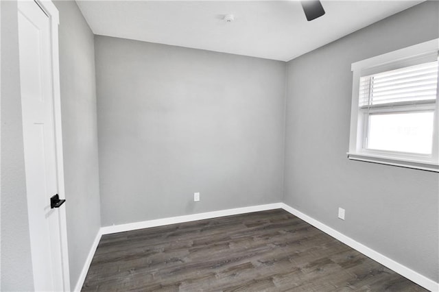 empty room with ceiling fan and dark hardwood / wood-style flooring