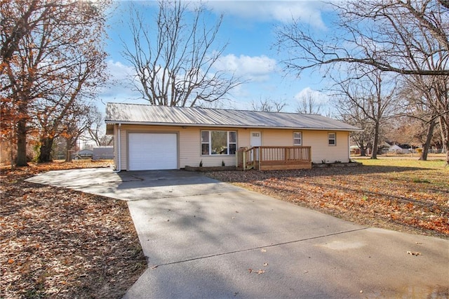 ranch-style home with a garage and a deck