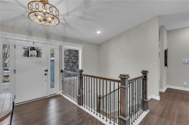 foyer featuring baseboards, a chandelier, dark wood-style flooring, and recessed lighting