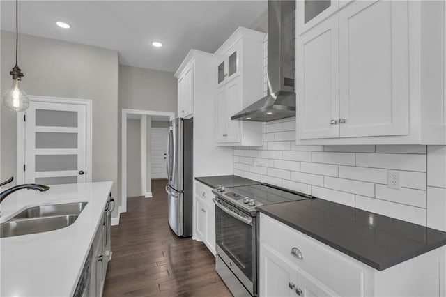 6975 W 162nd Ter, Overland Park, KS 66085 - kitchen with stainless steel appliances, wall chimney exhaust hood, dark wood finished floors, decorative backsplash, and white cabinetry