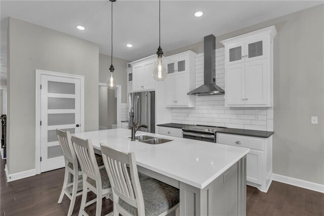 6975 W 162nd Ter, Overland Park, KS 66085 - kitchen with wall chimney exhaust hood, appliances with stainless steel finishes, backsplash, dark wood-type flooring, and recessed lighting
