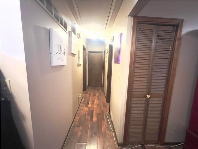 hall featuring dark wood-type flooring and crown molding