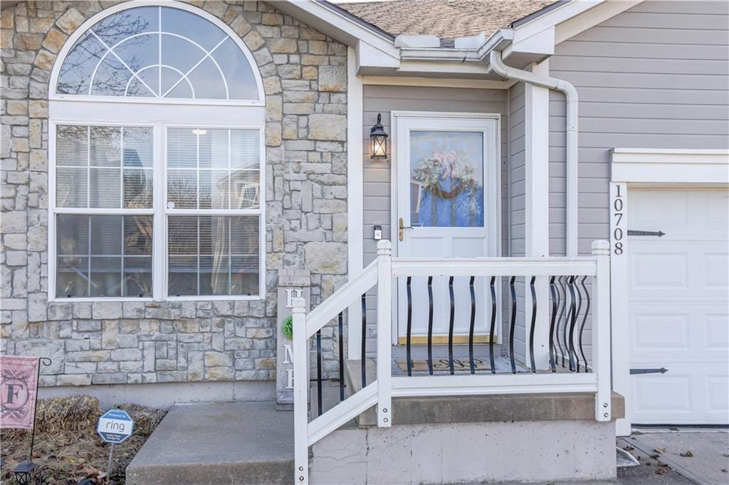 doorway to property with a garage