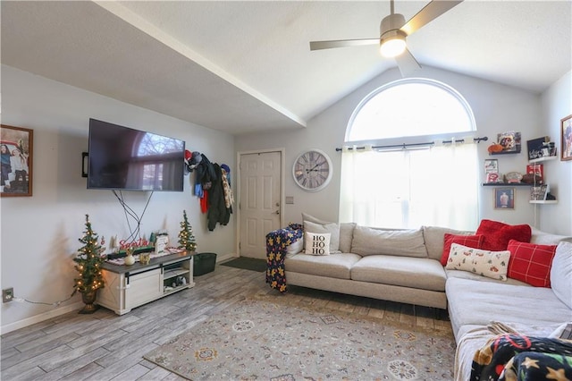 living room with vaulted ceiling with beams, light hardwood / wood-style flooring, and ceiling fan