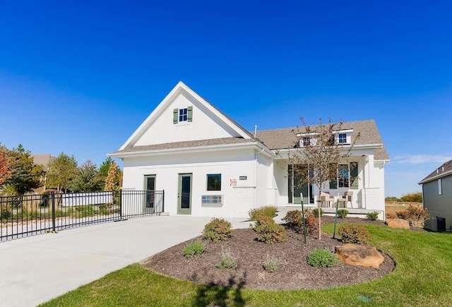 back of property with covered porch and central AC unit