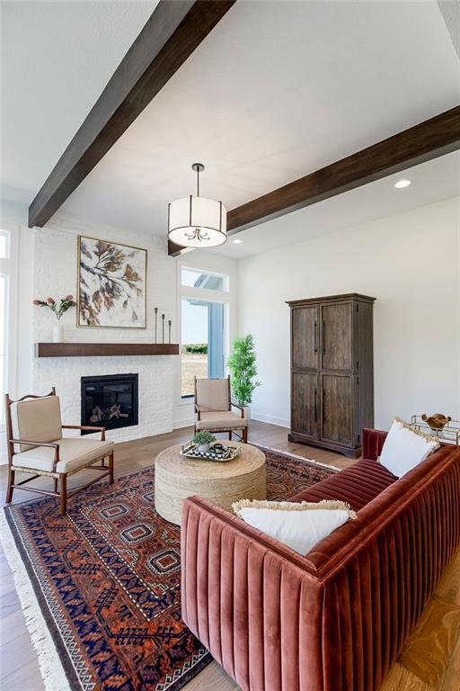 living room with beam ceiling and hardwood / wood-style floors