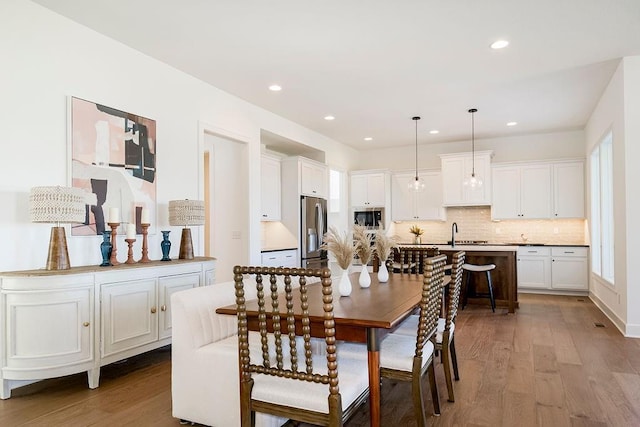 dining room featuring hardwood / wood-style flooring and sink