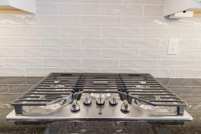 room details with decorative backsplash and stainless steel gas cooktop