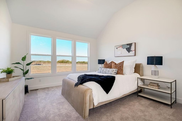 carpeted bedroom with vaulted ceiling