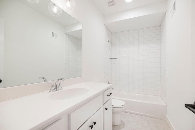 full bathroom with tile patterned flooring, vanity, tiled shower / bath combo, and toilet