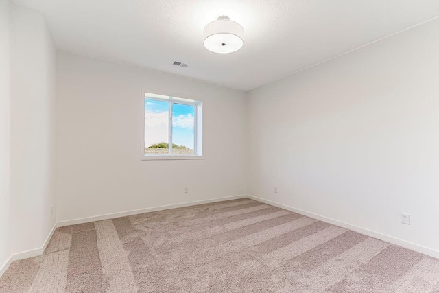 unfurnished room featuring light colored carpet