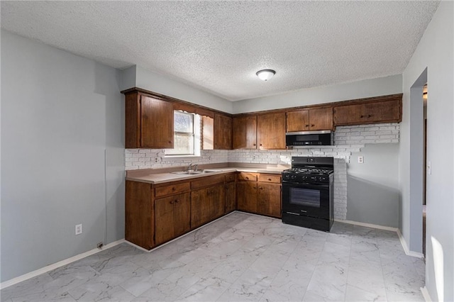 kitchen with decorative backsplash, a textured ceiling, gas stove, and sink