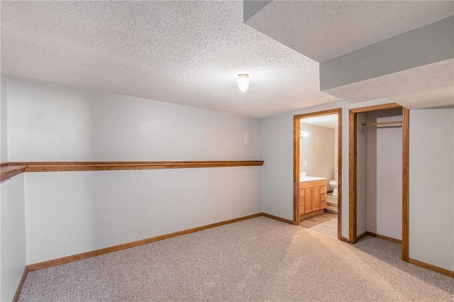 interior space featuring light carpet and a textured ceiling