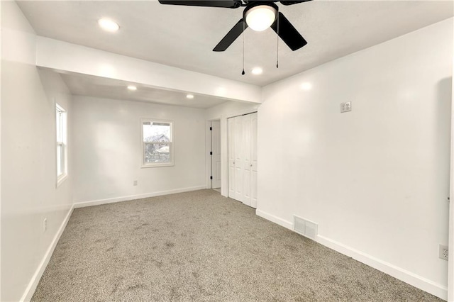 unfurnished room with ceiling fan and carpet floors